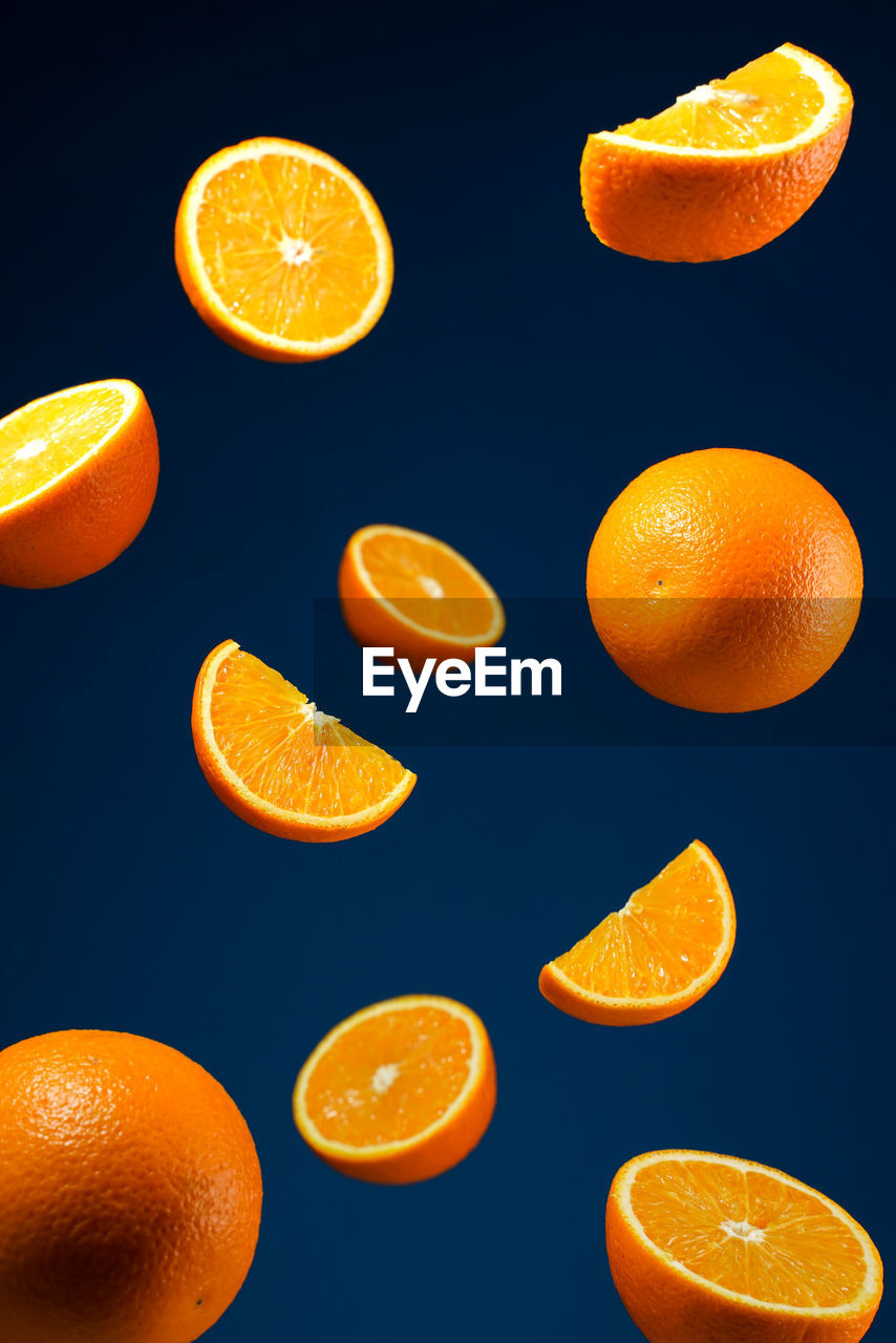 Close-up of orange slices against blue background