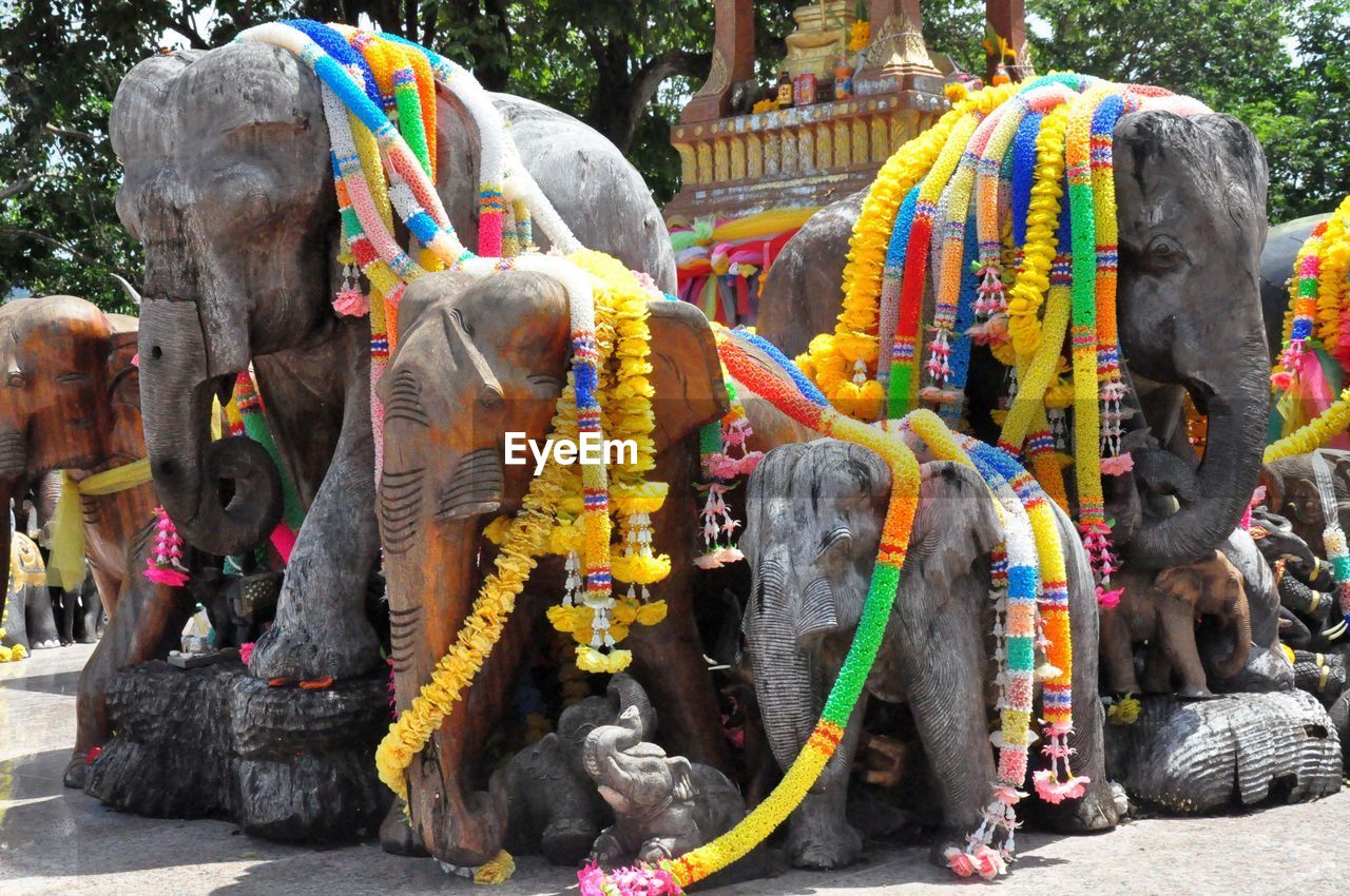 Colorful garlands on elephants statues