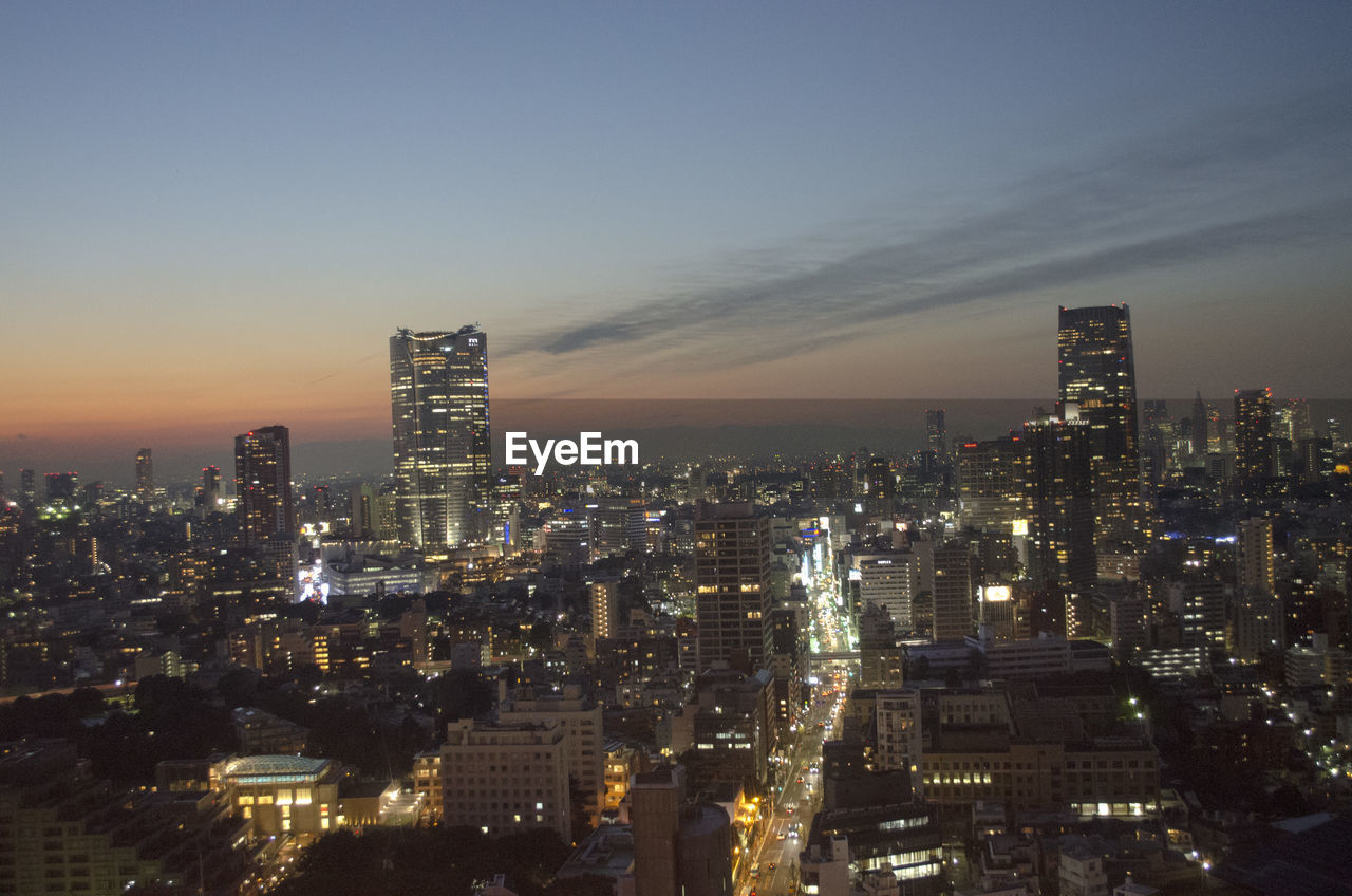 High angle view of city lit up at night