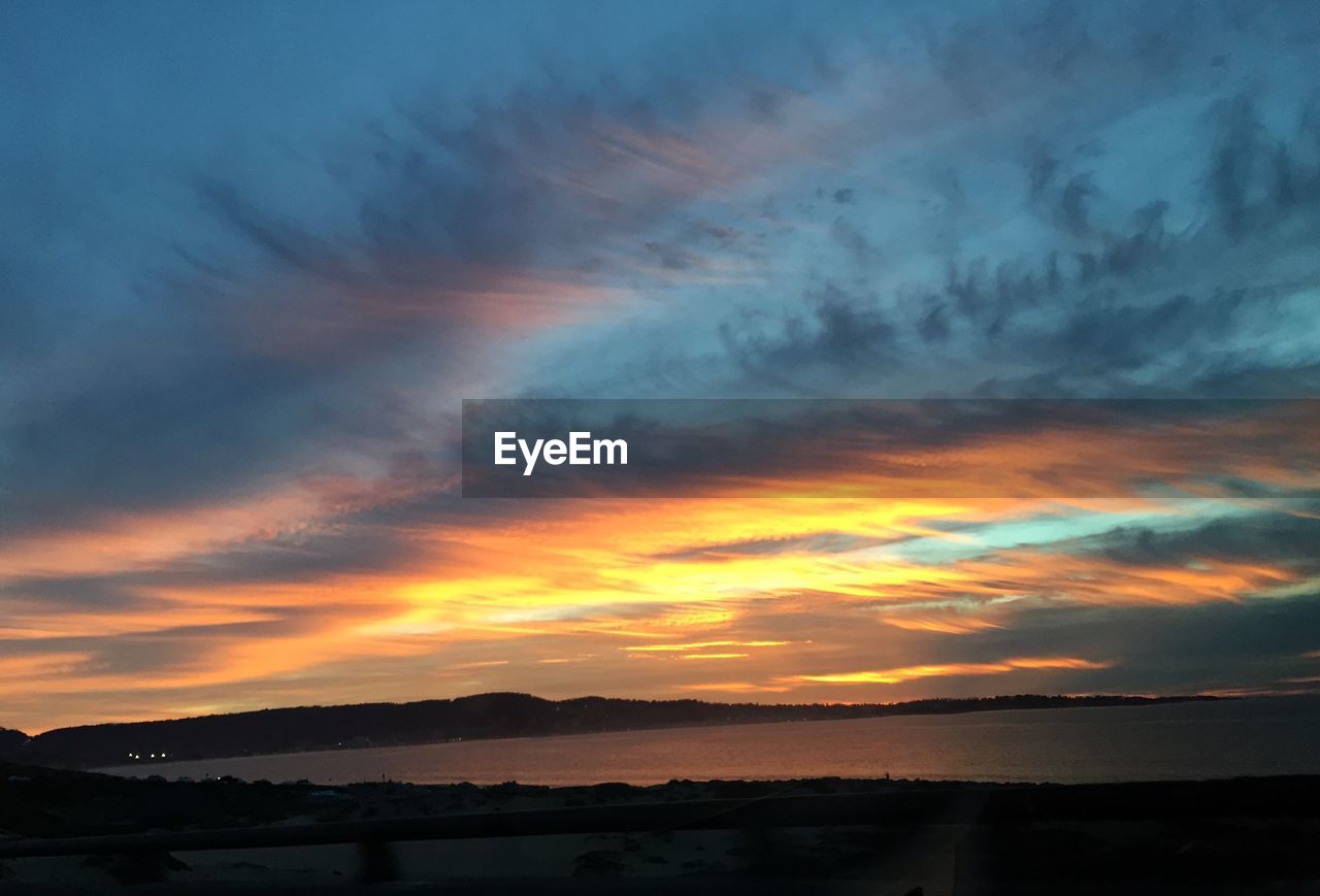 Scenic view of sea against orange sky