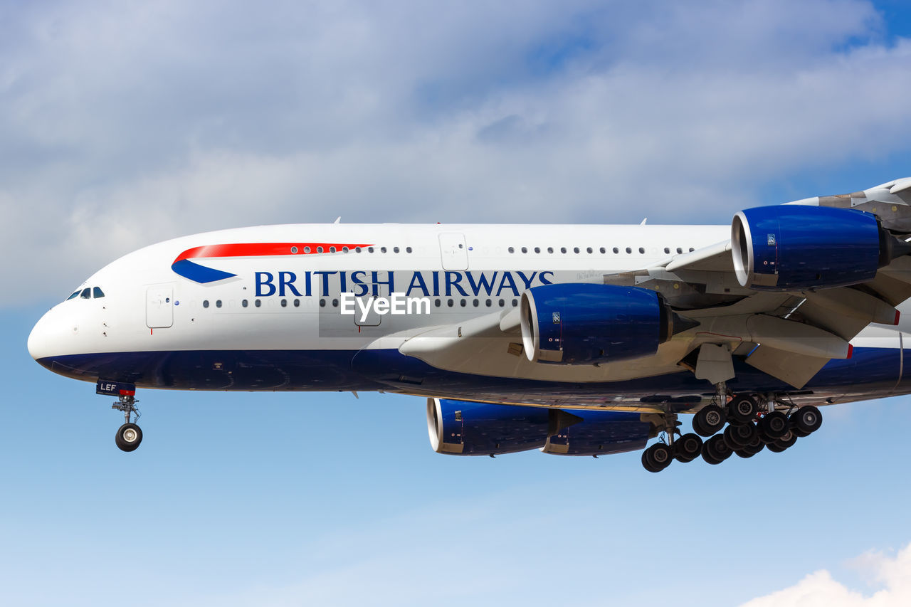 LOW ANGLE VIEW OF AIRPLANE FLYING IN SKY