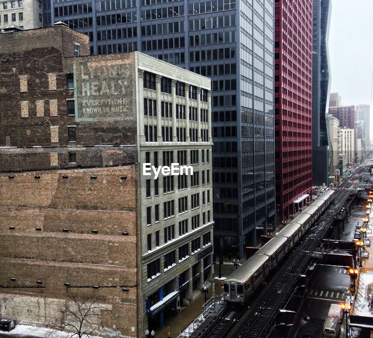 High angle view of train by buildings in city