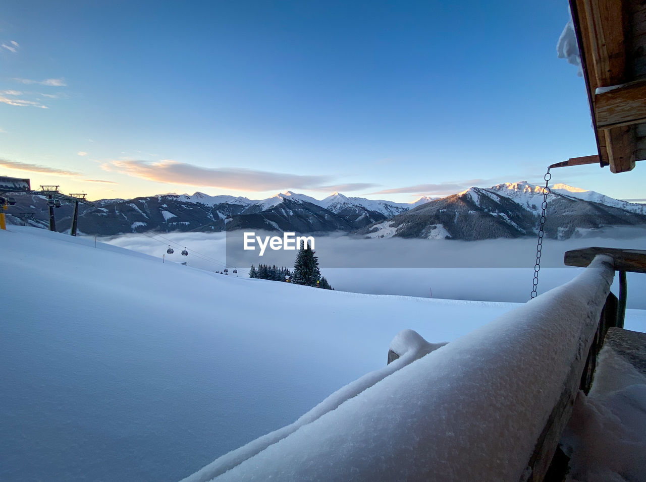 SNOW COVERED MOUNTAINS AGAINST SKY