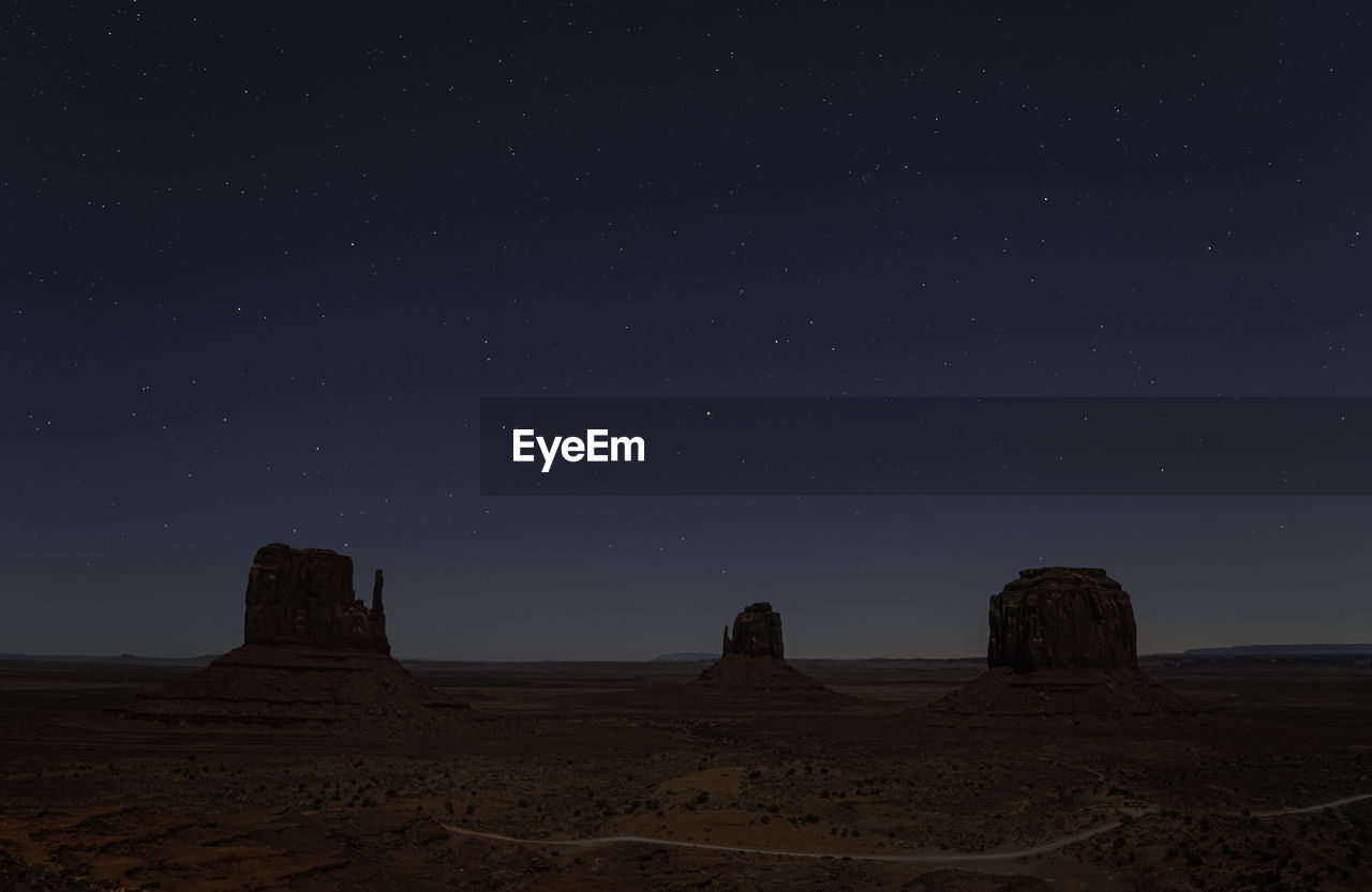 Scenic view of rock formation against sky at night