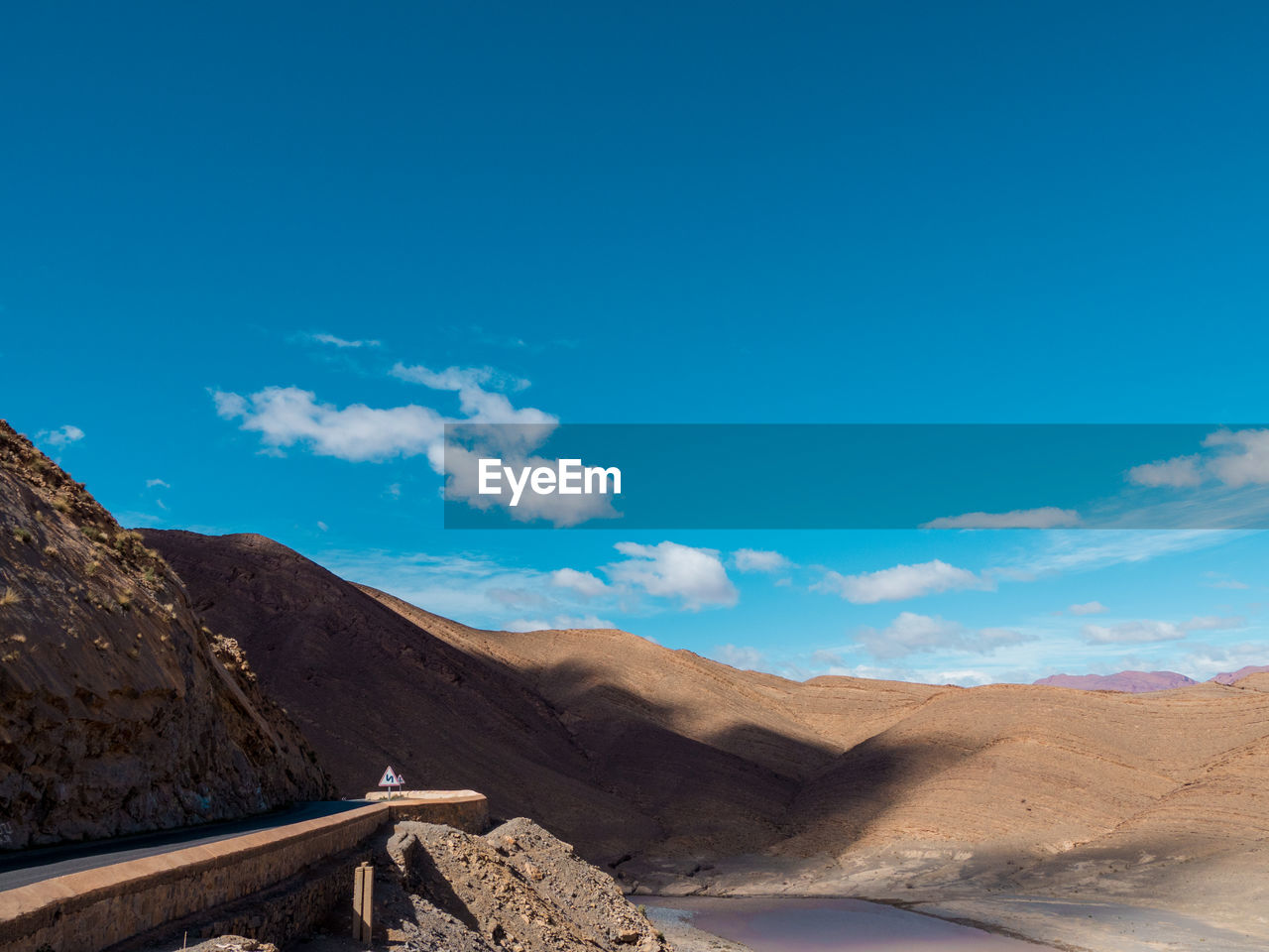 Scenic view of mountains against blue sky