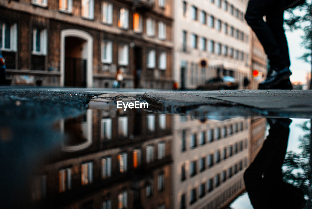 Reflection of built structure in puddle