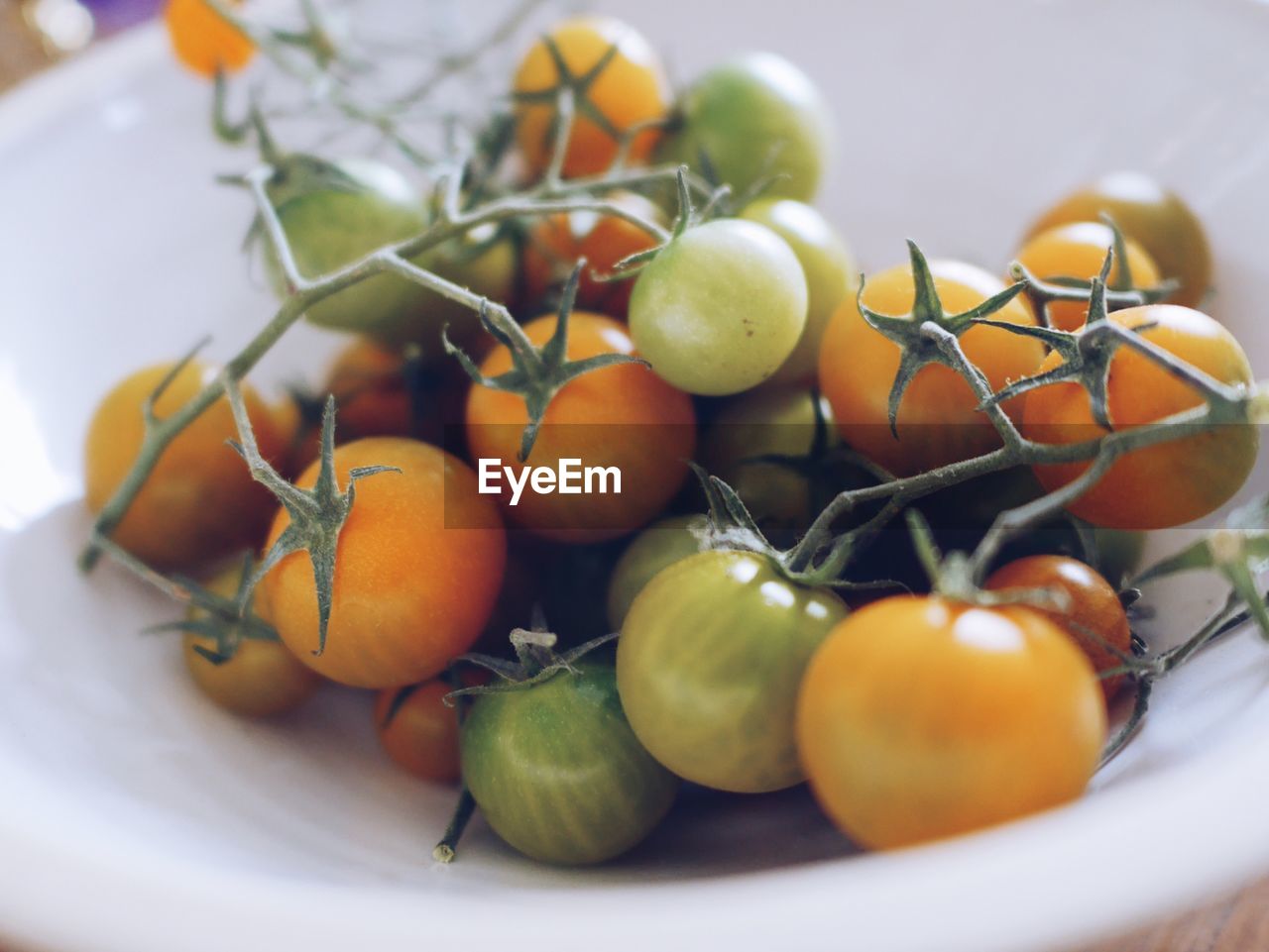 Close-up of cherry tomato in bowl on table