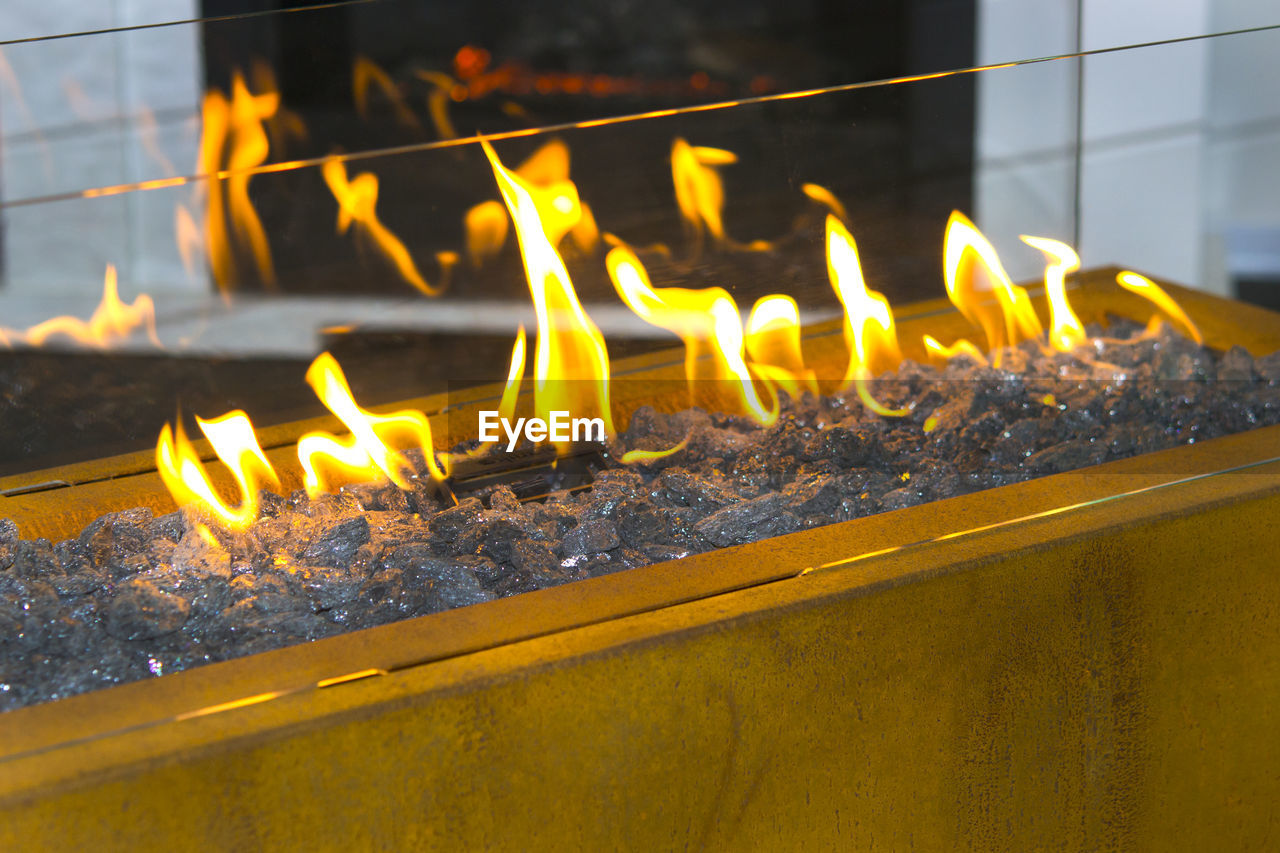 CLOSE-UP OF LIT CANDLES IN TEMPLE