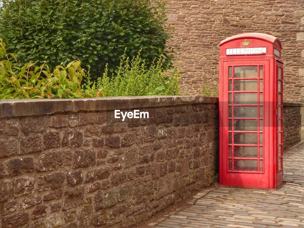 RED TEXT ON STONE WALL