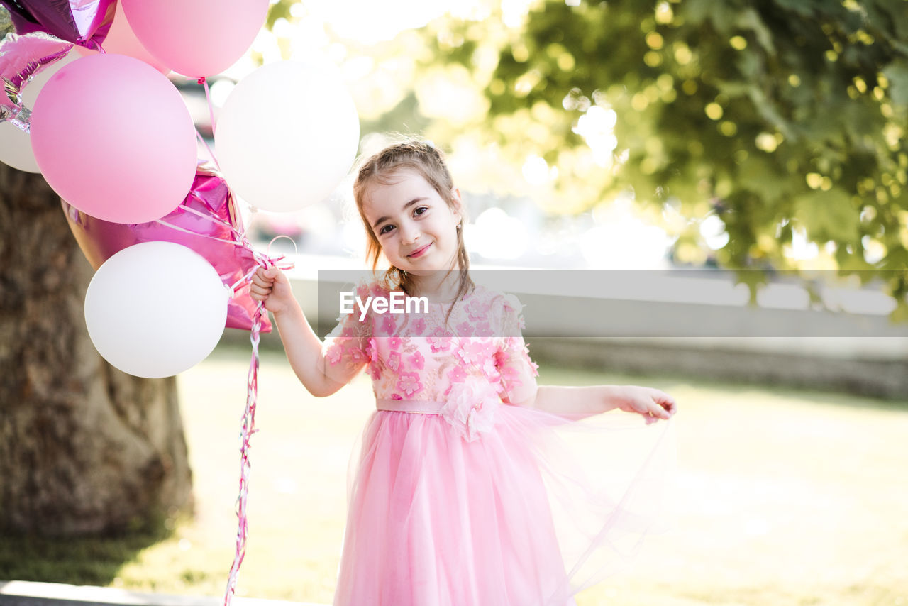 Portrait of cute girl with balloons