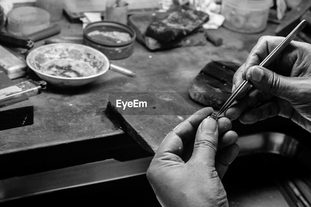 Cropped image of jeweller working in workshop