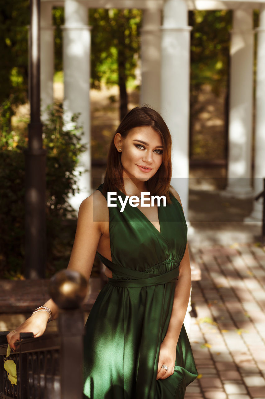 Portrait of smiling young woman standing outdoors