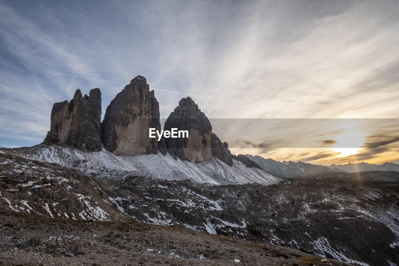 Scenic view of rocky mountains against sky during sunset