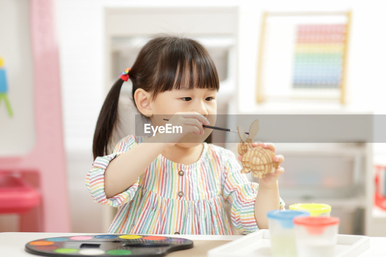 Young girl making craft for homeschooling