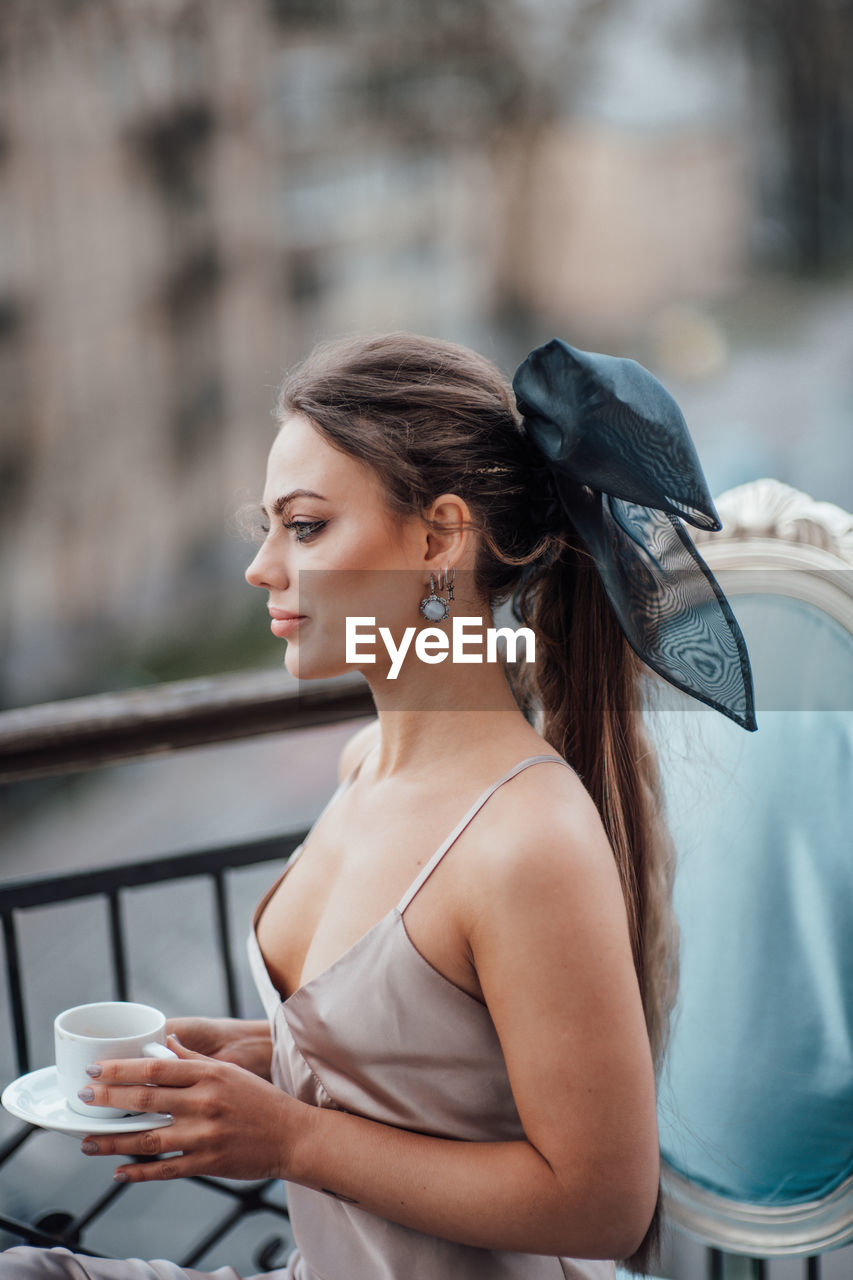 Young woman drinking coffee cup