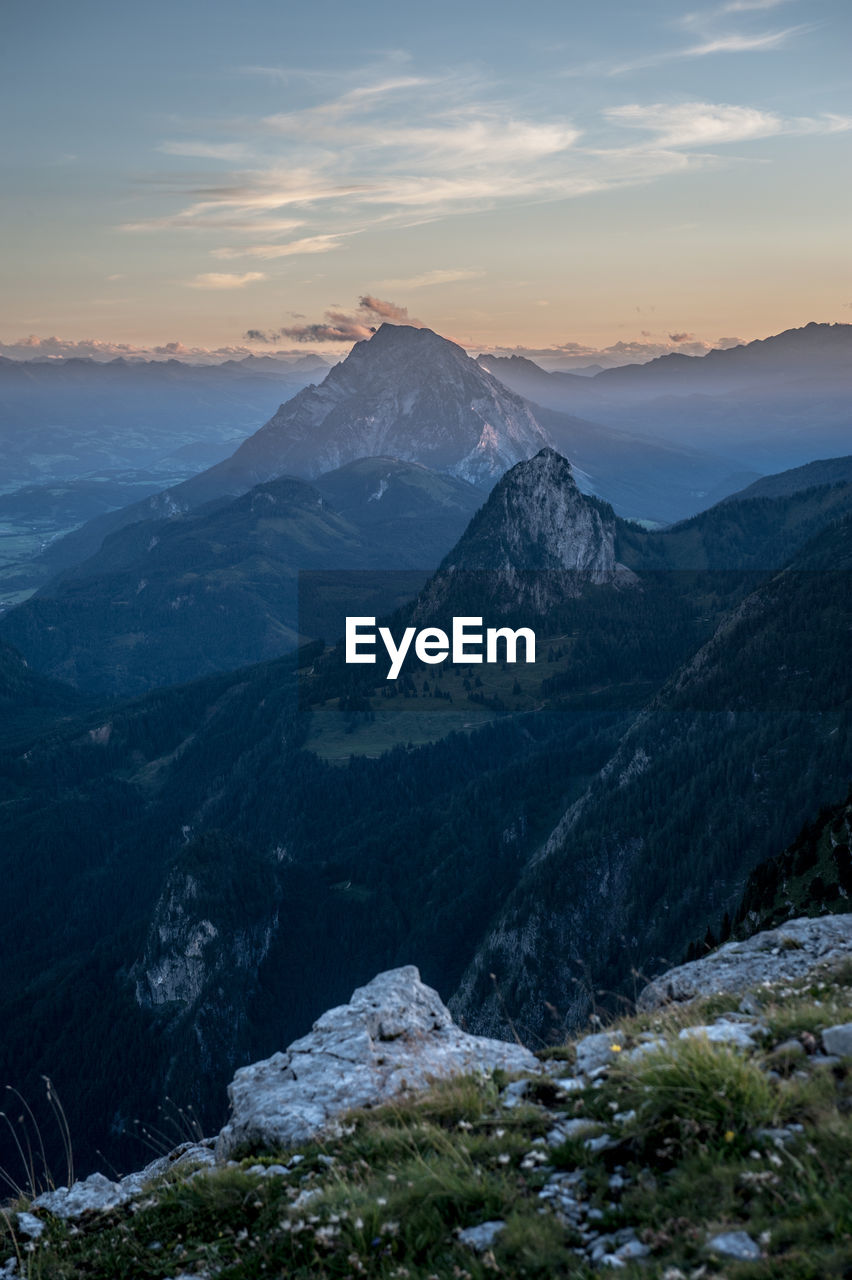 Scenic view of snowcapped mountains against sky during sunset