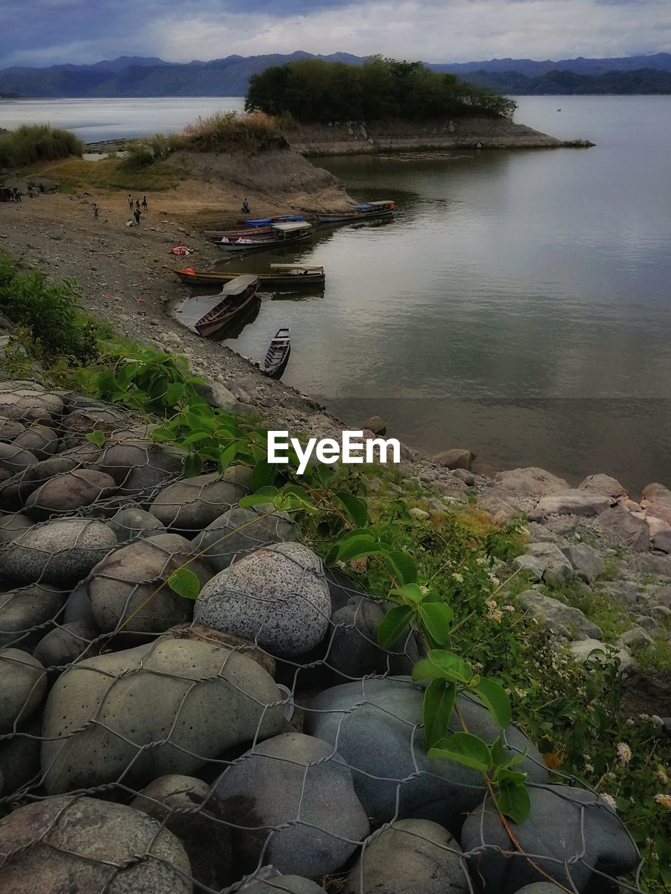 High angle view of rocks by river against sky