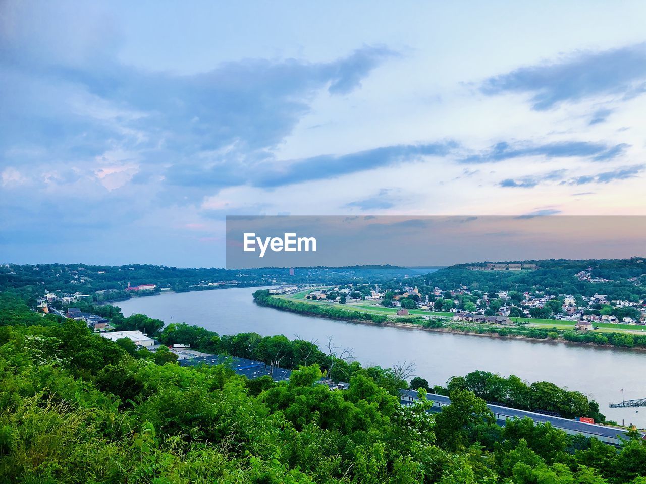 High angle view of river and cityscape against sky