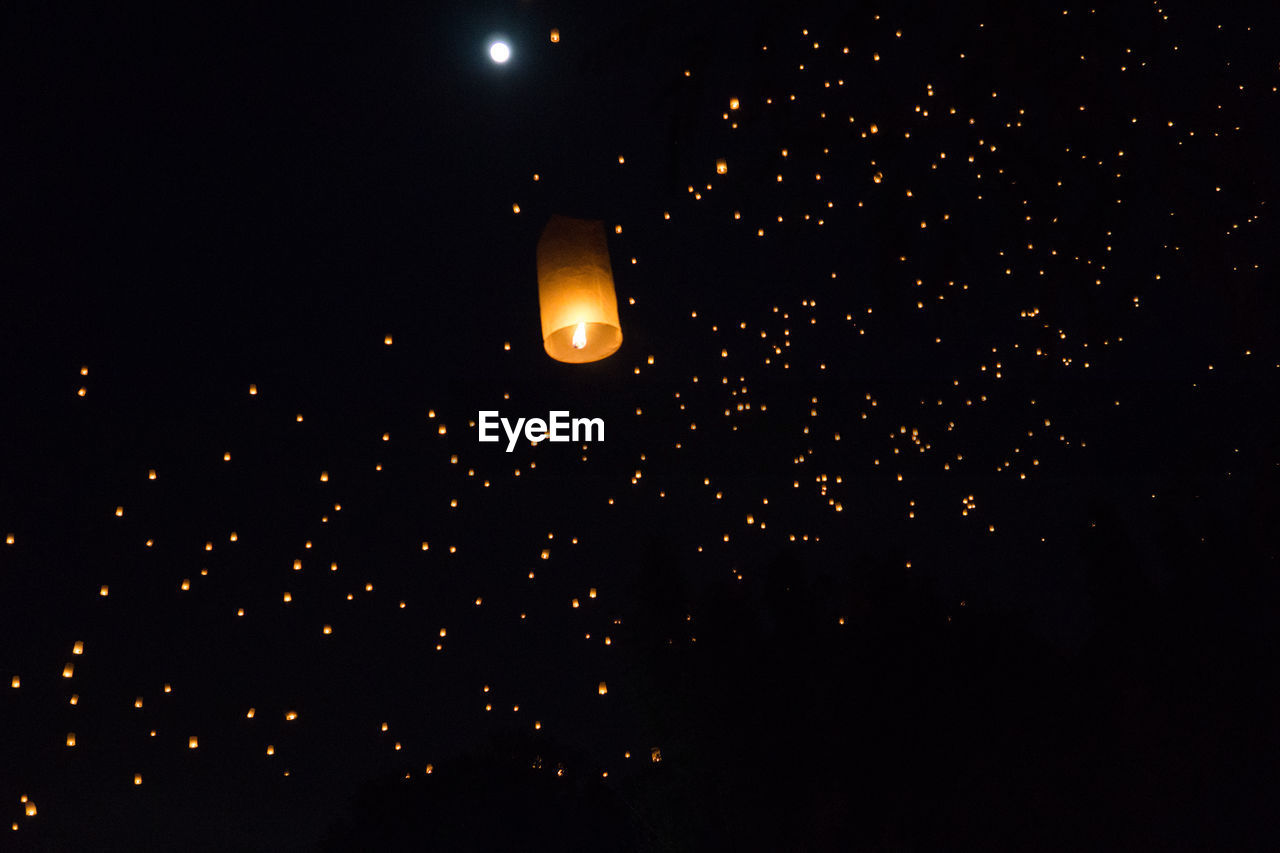 LOW ANGLE VIEW OF ILLUMINATED LANTERN AGAINST SKY