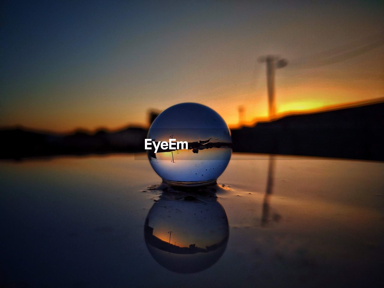 CLOSE-UP OF WATER AGAINST SKY AT SUNSET