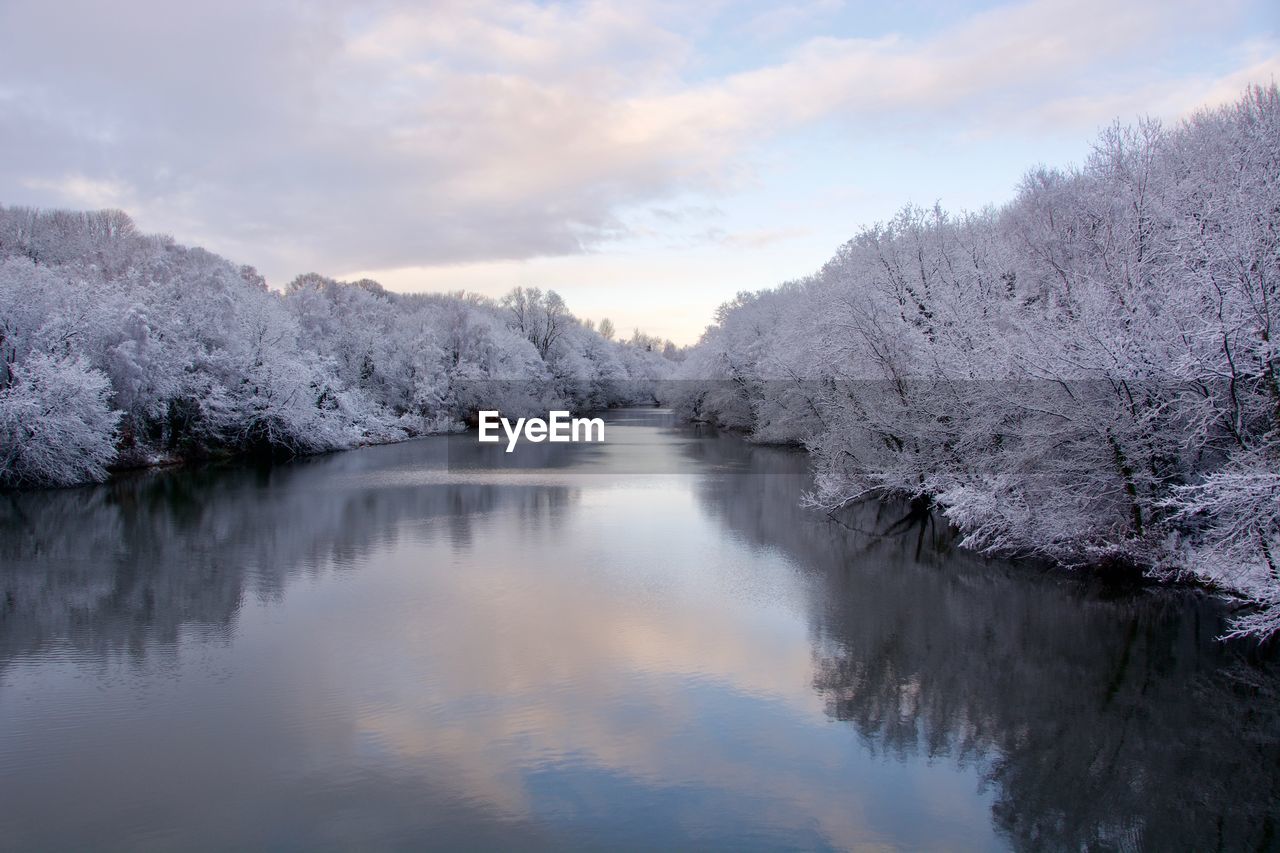 Scenic view of lake against sky during winter