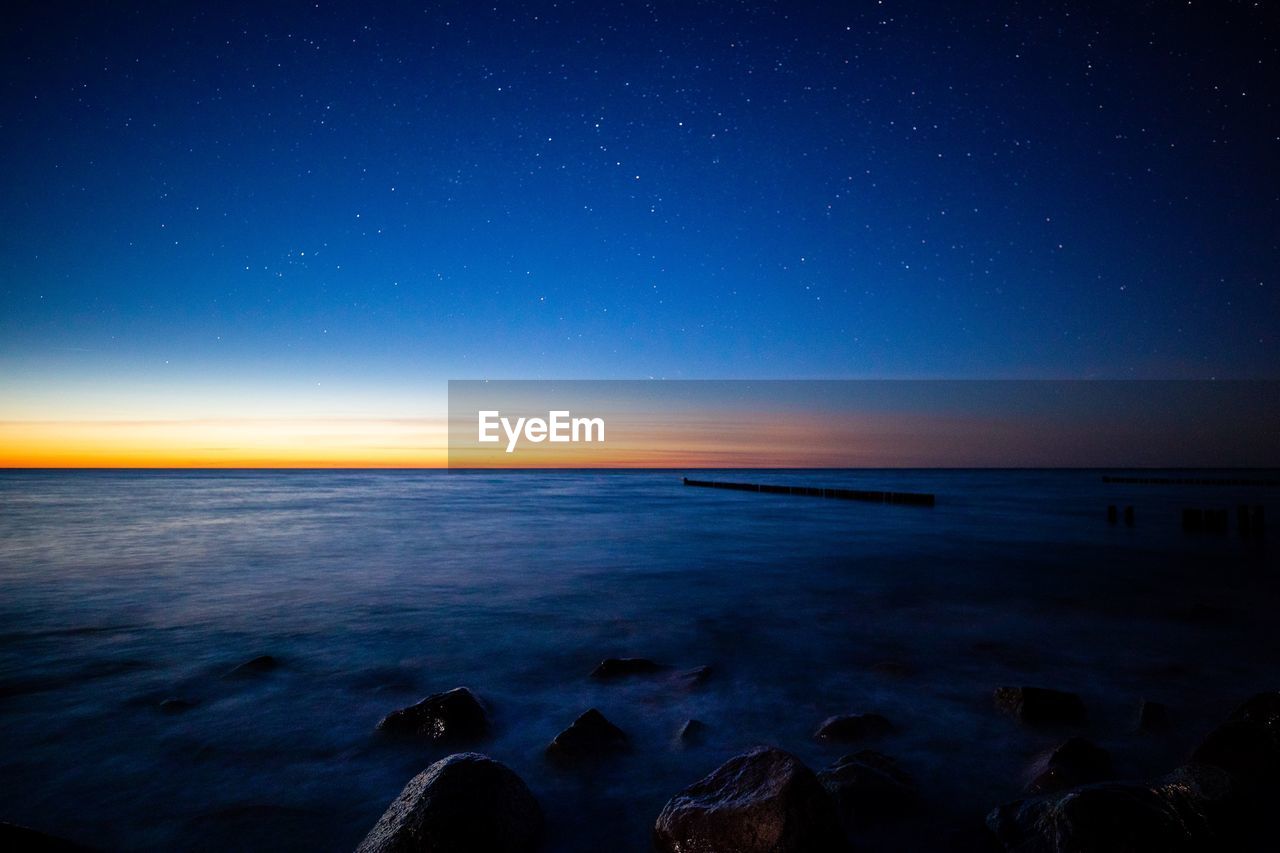 Scenic view of sea against sky at night