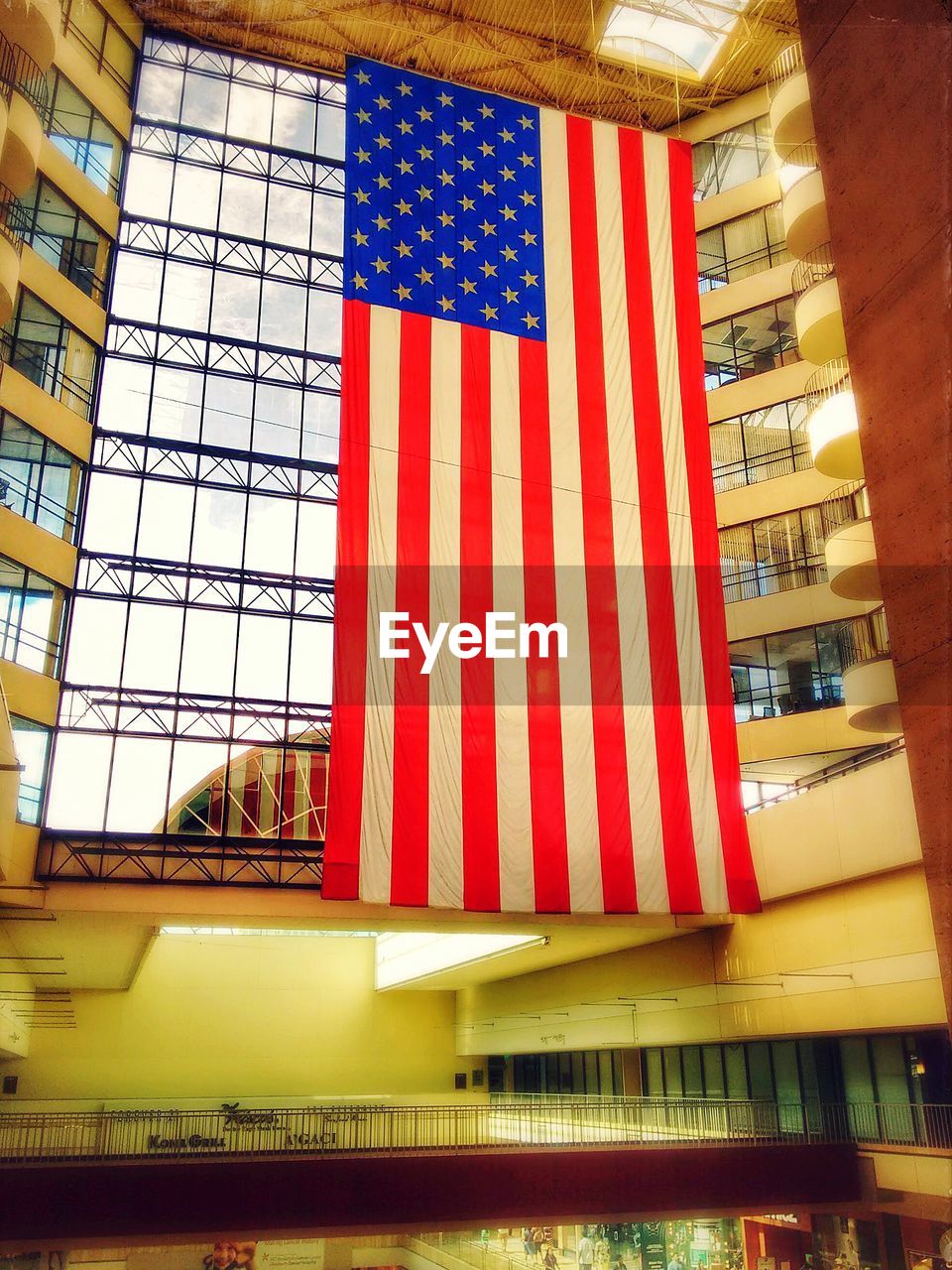 Low angle view of american flag hanging at shopping mall