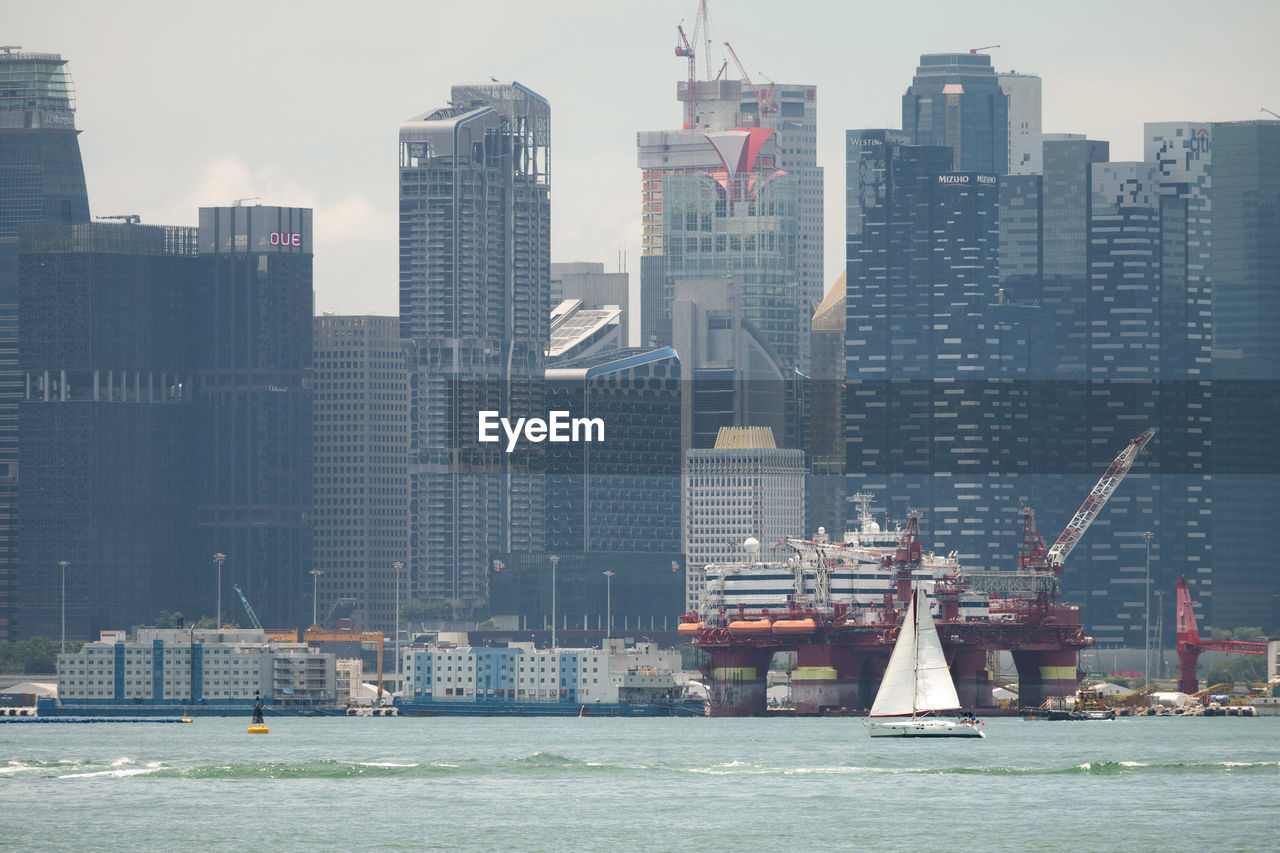 MODERN BUILDINGS BY SEA AGAINST SKY