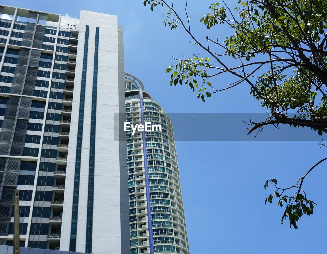 Low angle view of modern buildings against blue sky