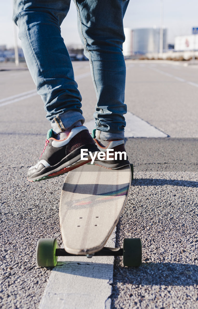 Close-up of anonymous man on longboard