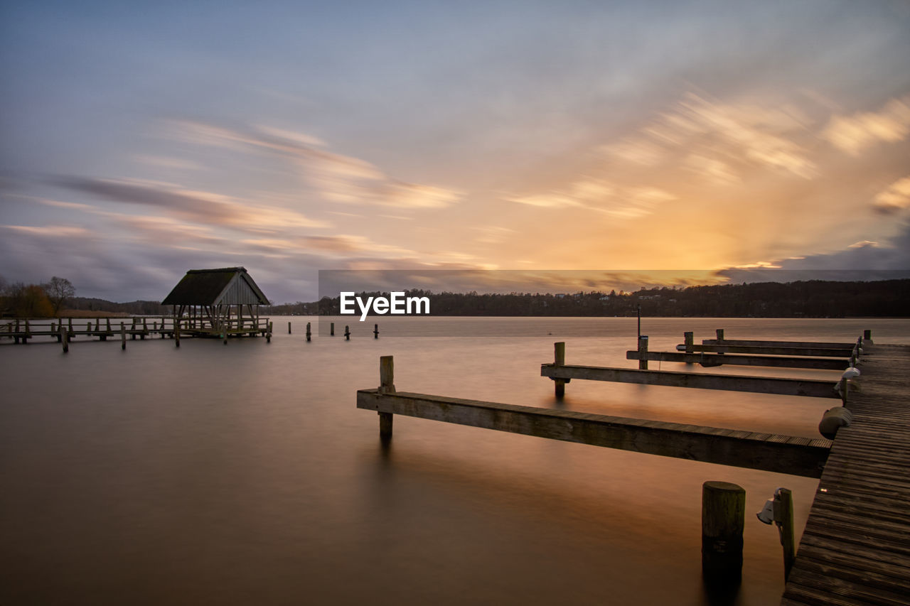 PIER OVER SEA AGAINST SKY AT SUNSET