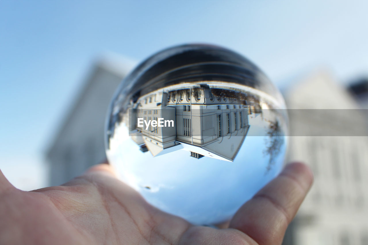 Close-up of person holding a sphere of glass - greifswald's theater