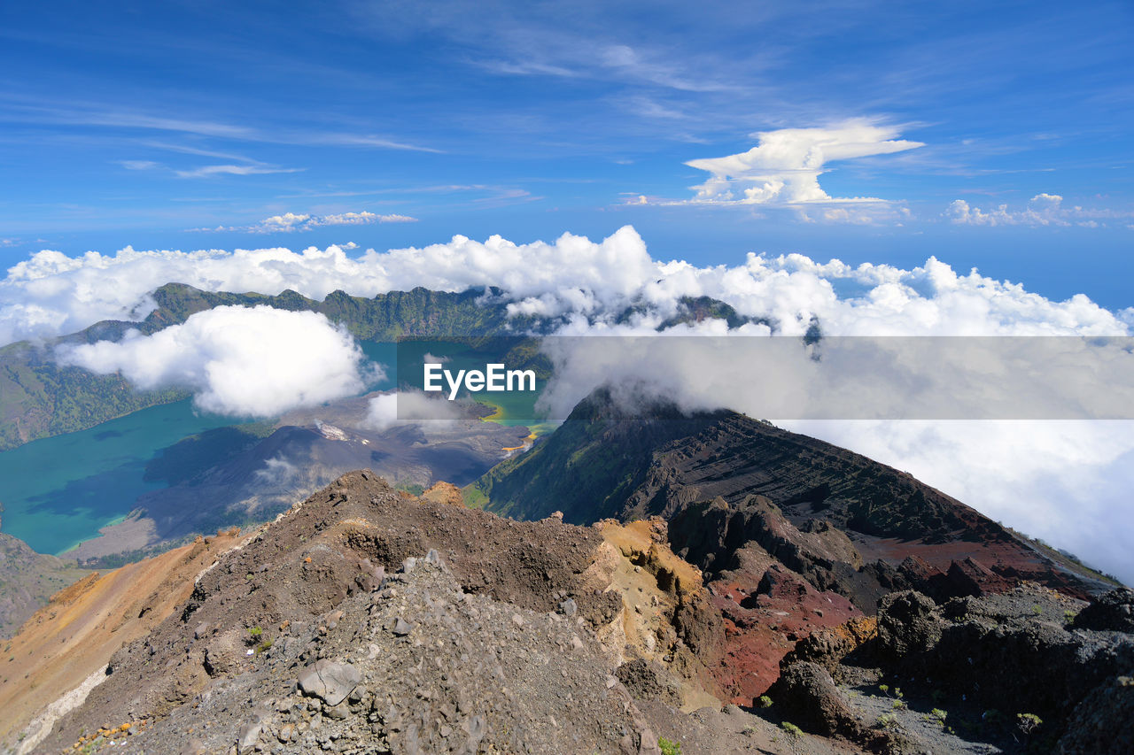 Scenic view of clouds over volcanic landscape against sky