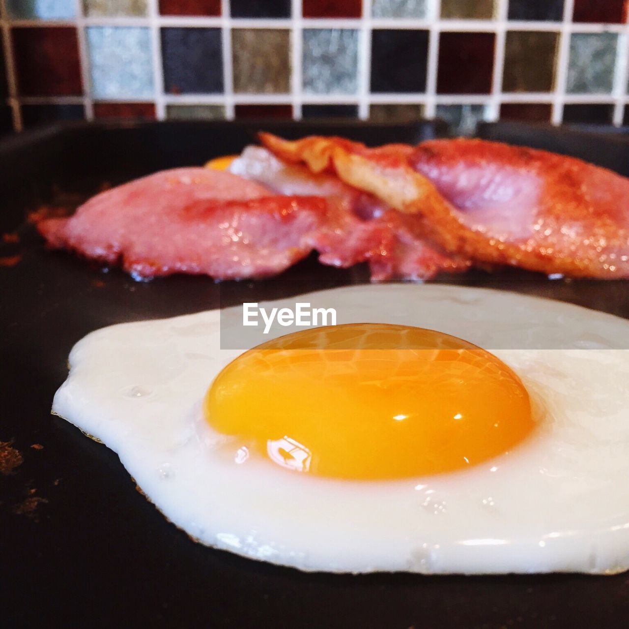 Close-up of egg frying on pan