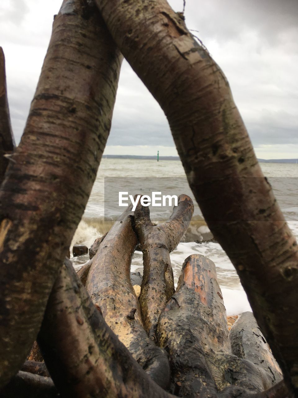 CLOSE-UP OF RUSTY METAL ON BEACH