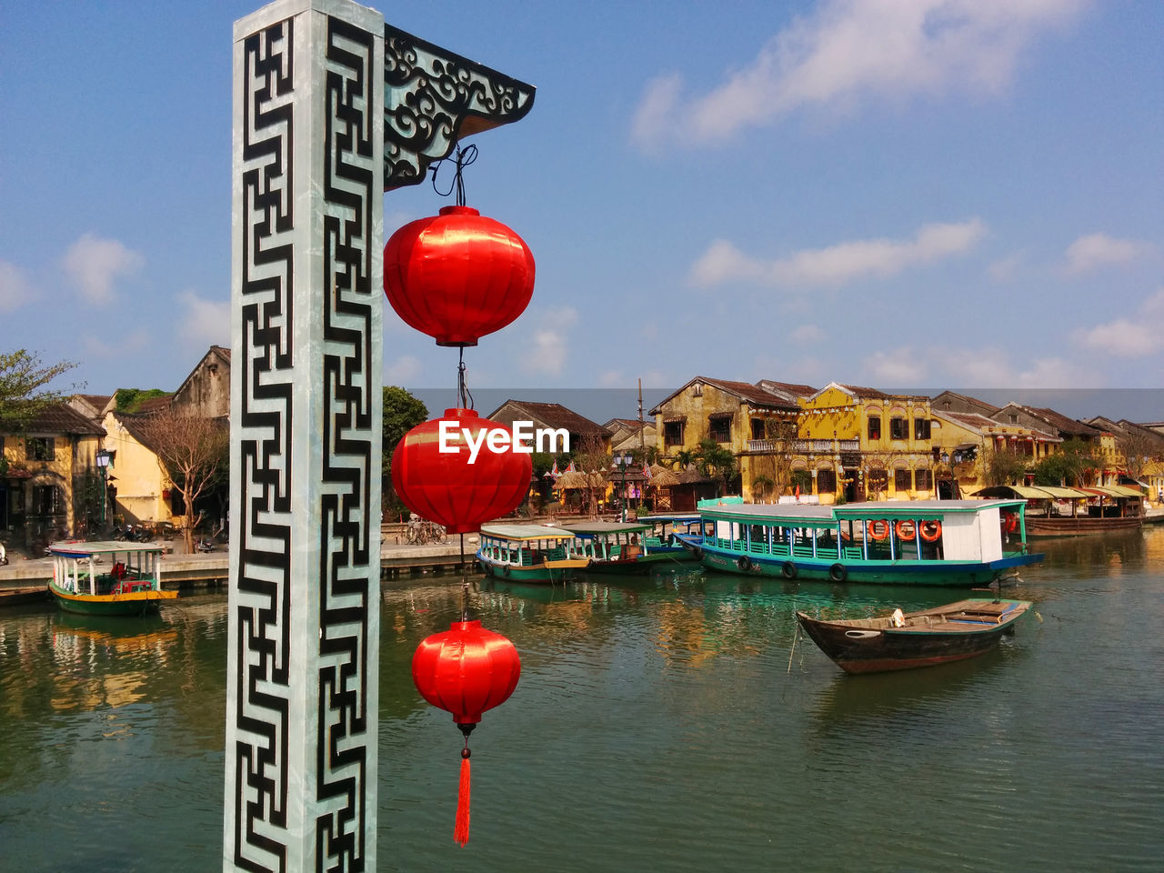 High angle view of stationary boats in river with chinese lanterns in foreground