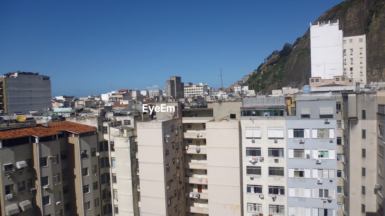 VIEW OF RESIDENTIAL BUILDINGS AGAINST CLEAR BLUE SKY