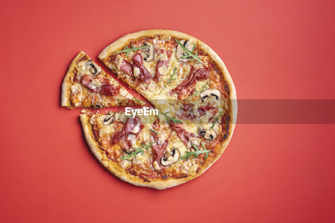 DIRECTLY ABOVE SHOT OF PIZZA AGAINST GRAY BACKGROUND