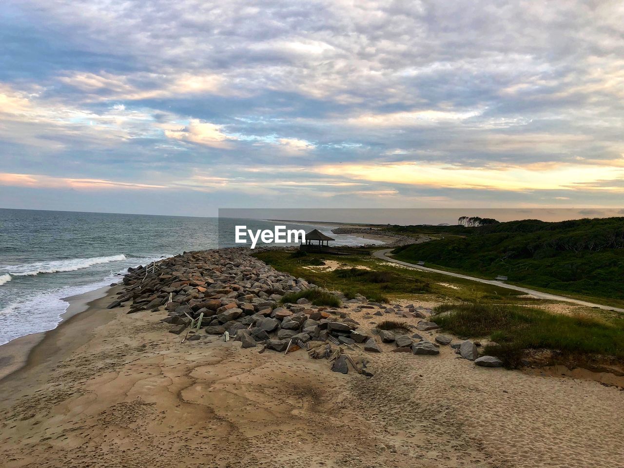 SCENIC VIEW OF BEACH DURING SUNSET