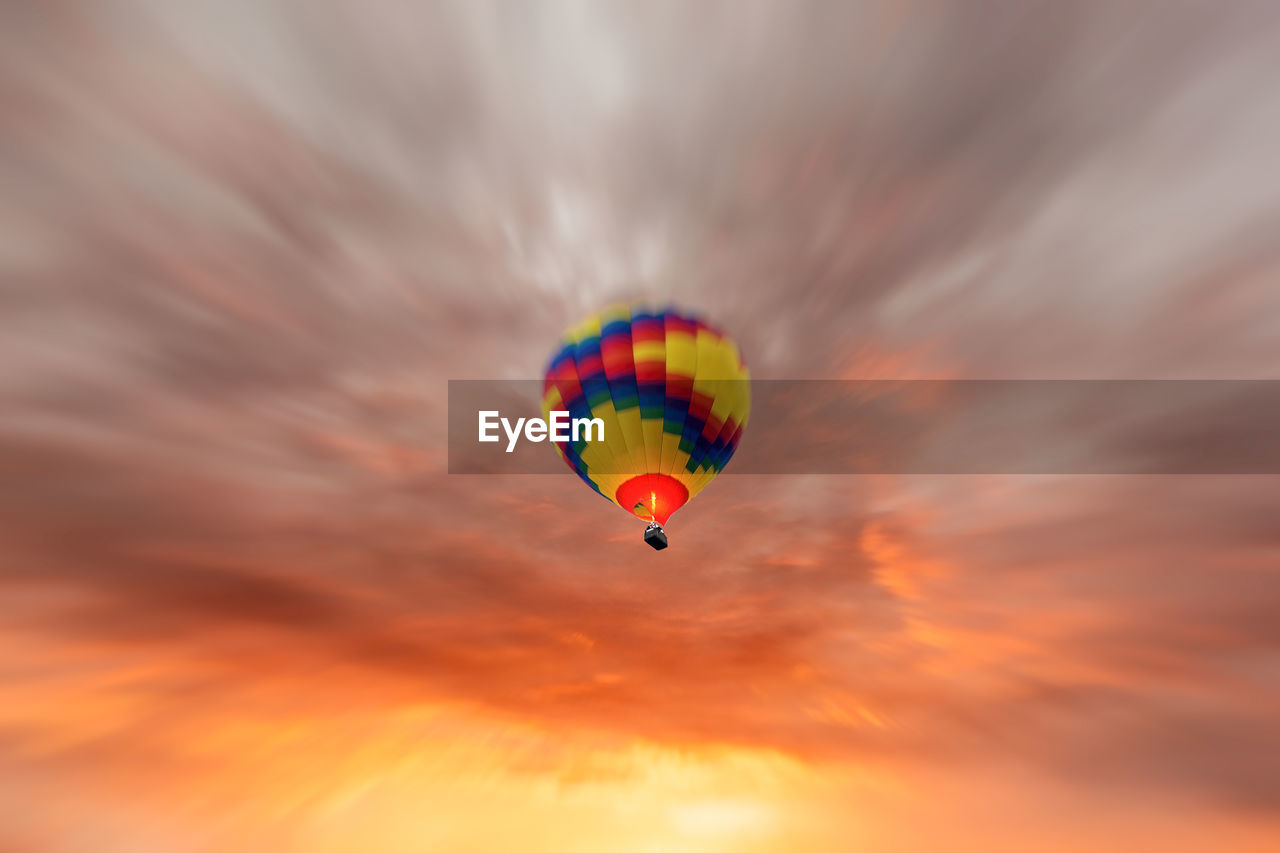 Low angle view of hot air balloon against orange sky