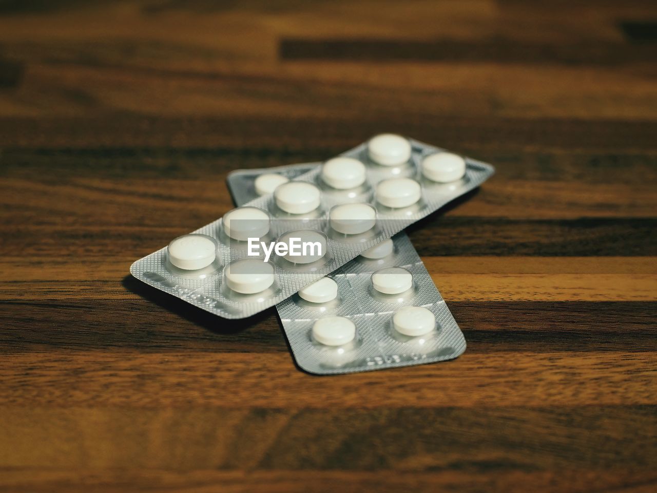 Close-up of pills on wooden table