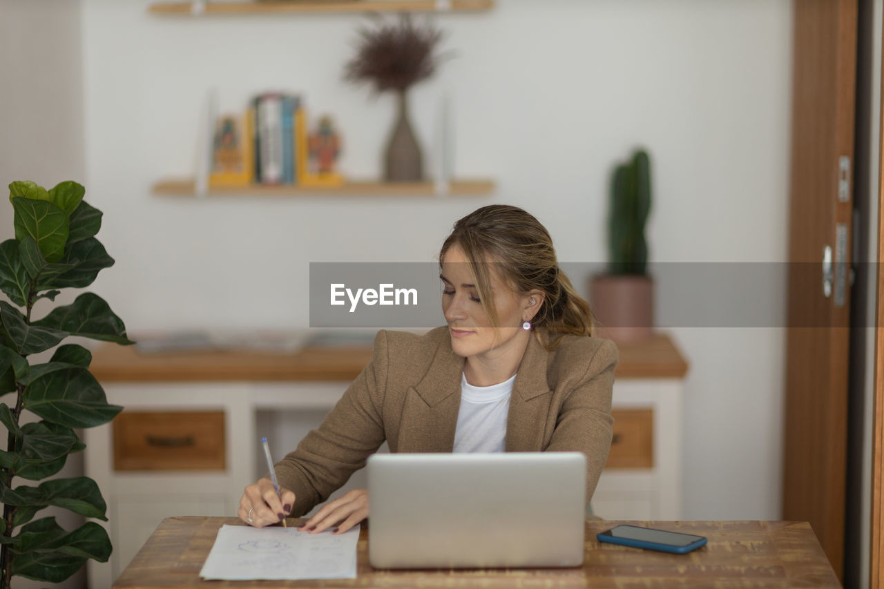 Woman working at home with laptop. home office.  notebook for working. 