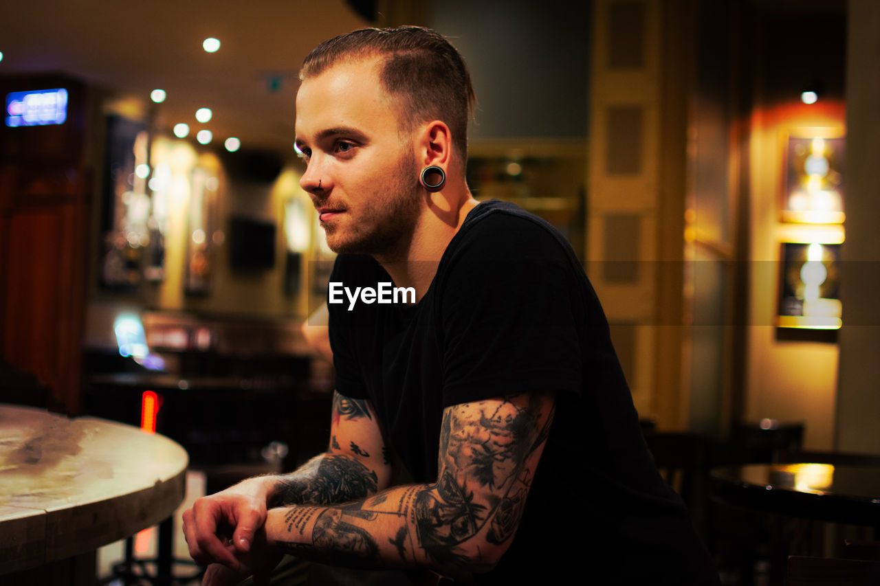 Close-up of tattooed man smiling