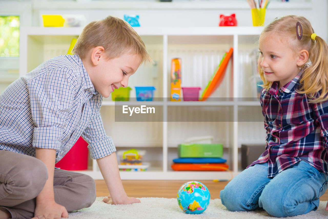 Smiling kids playing at home