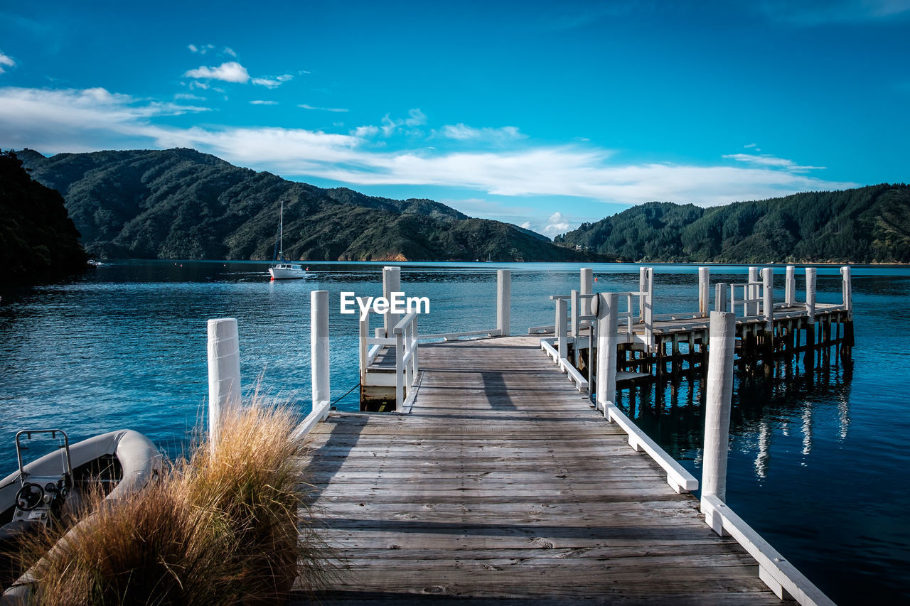 PIER OVER LAKE AGAINST SKY