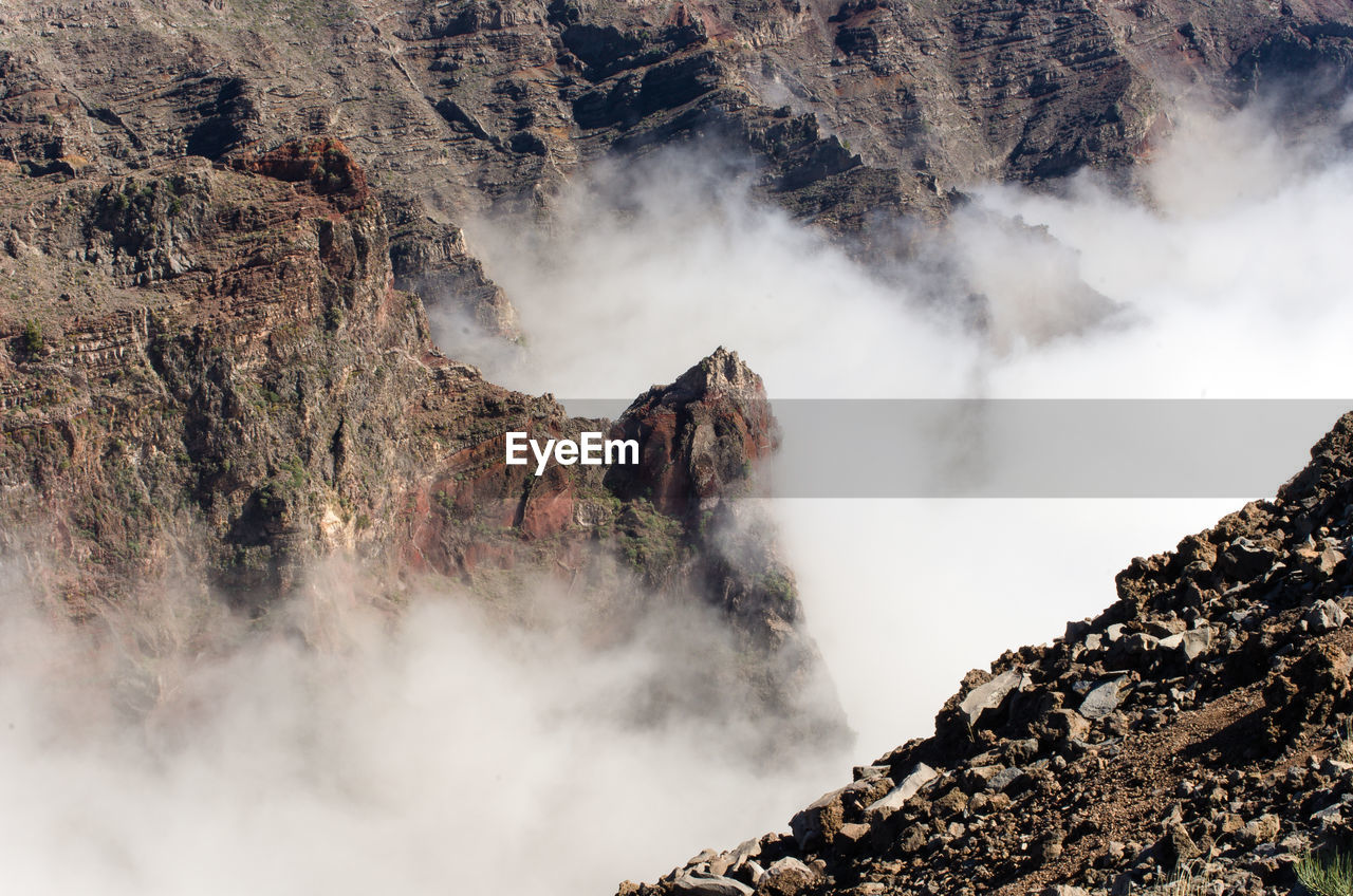 High angle view of rock formations in foggy weather