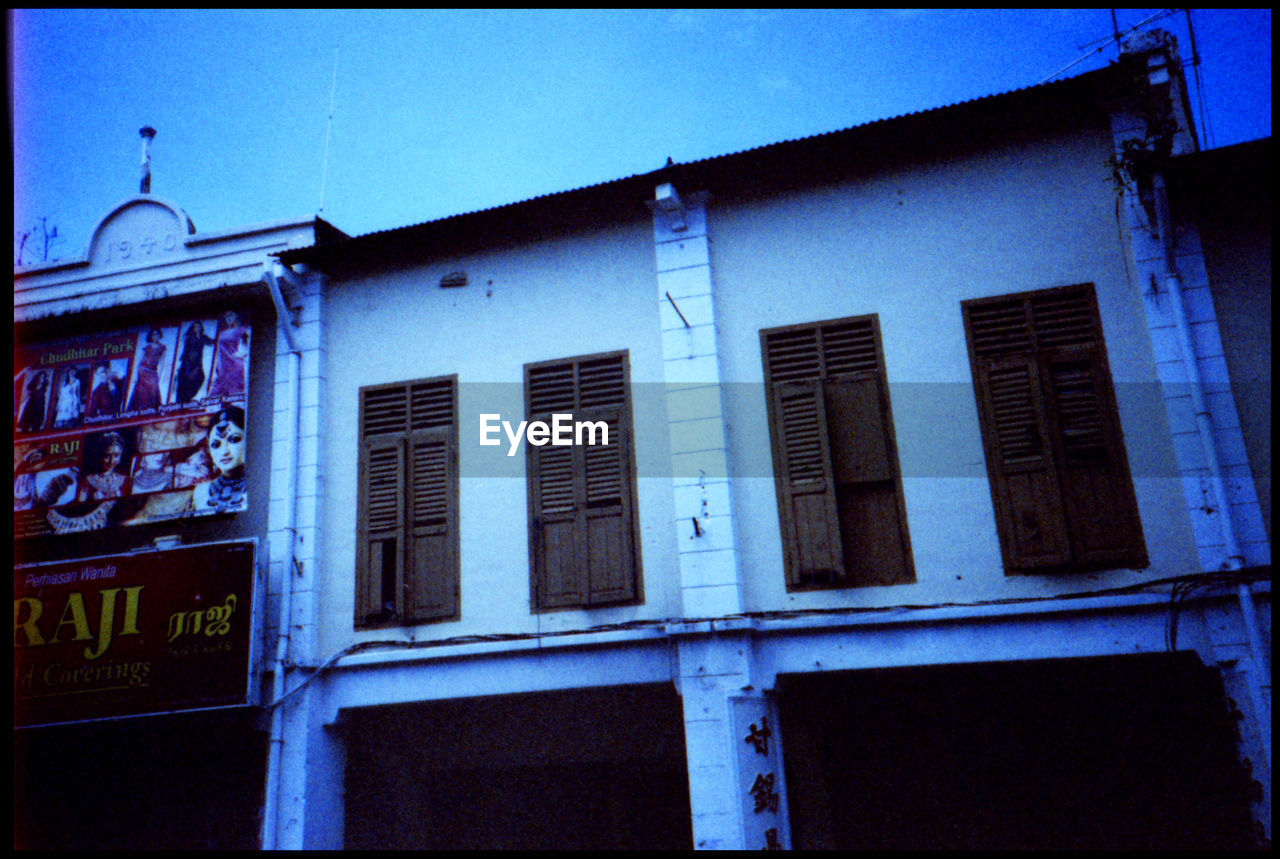 LOW ANGLE VIEW OF TEXT ON BUILDING EXTERIOR