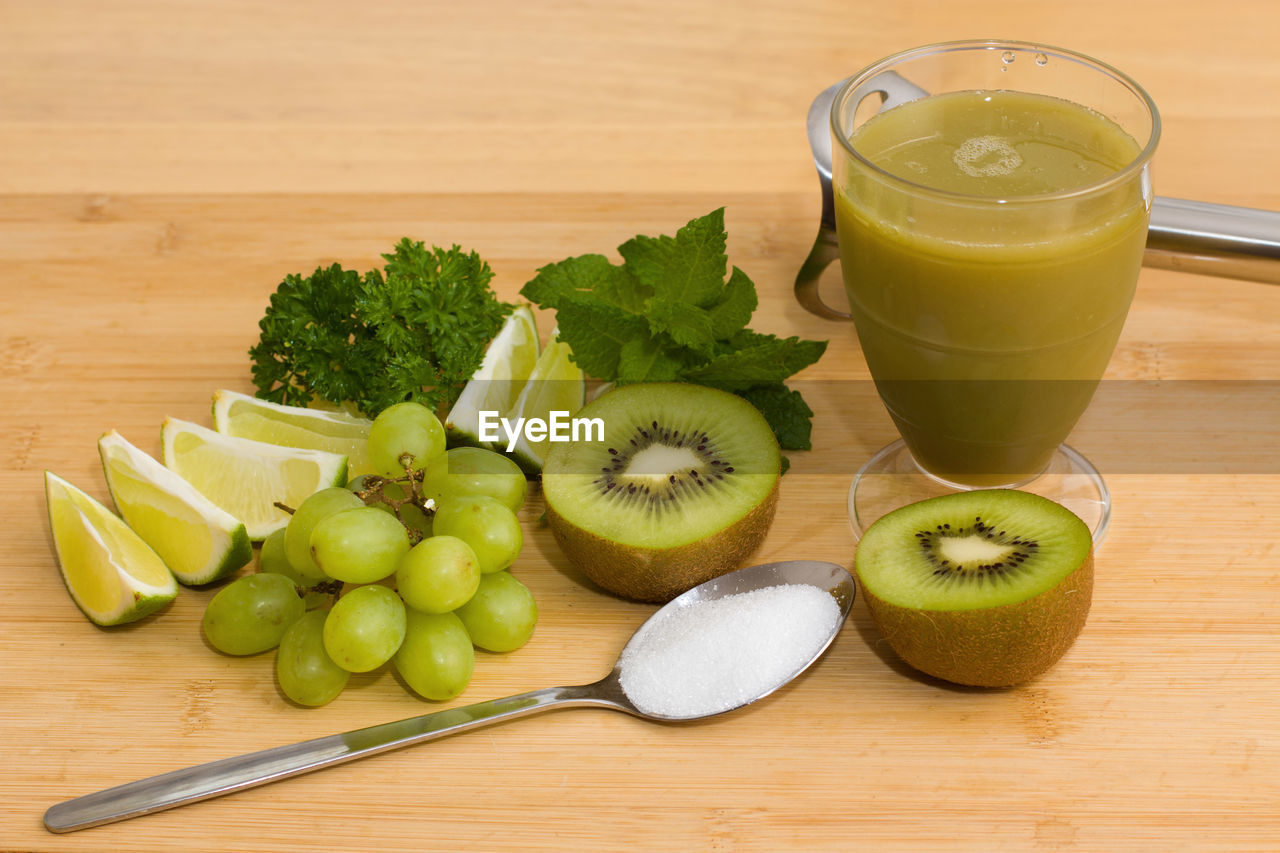 High angle view of fruits with juice on wooden table