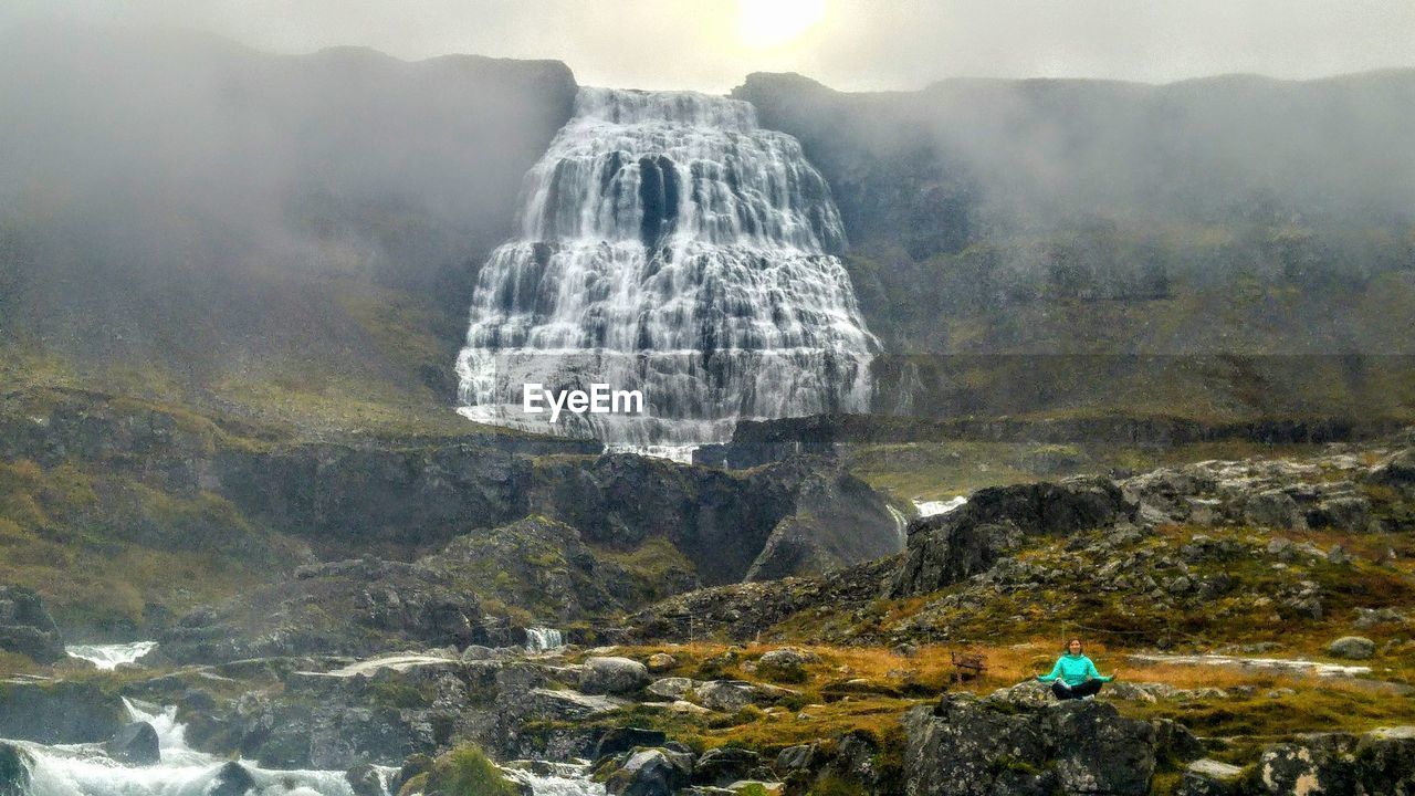 Scenic view of waterfall on mountains