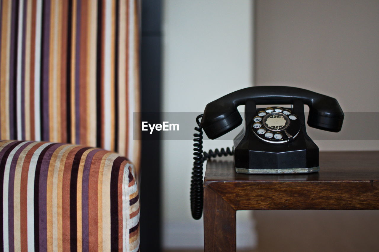 Close-up of rotary phone on table at home